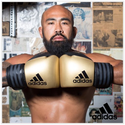 4003140300-boxing-gloves-adidas-hybrid-300-leather-black-gold-action1-800×800